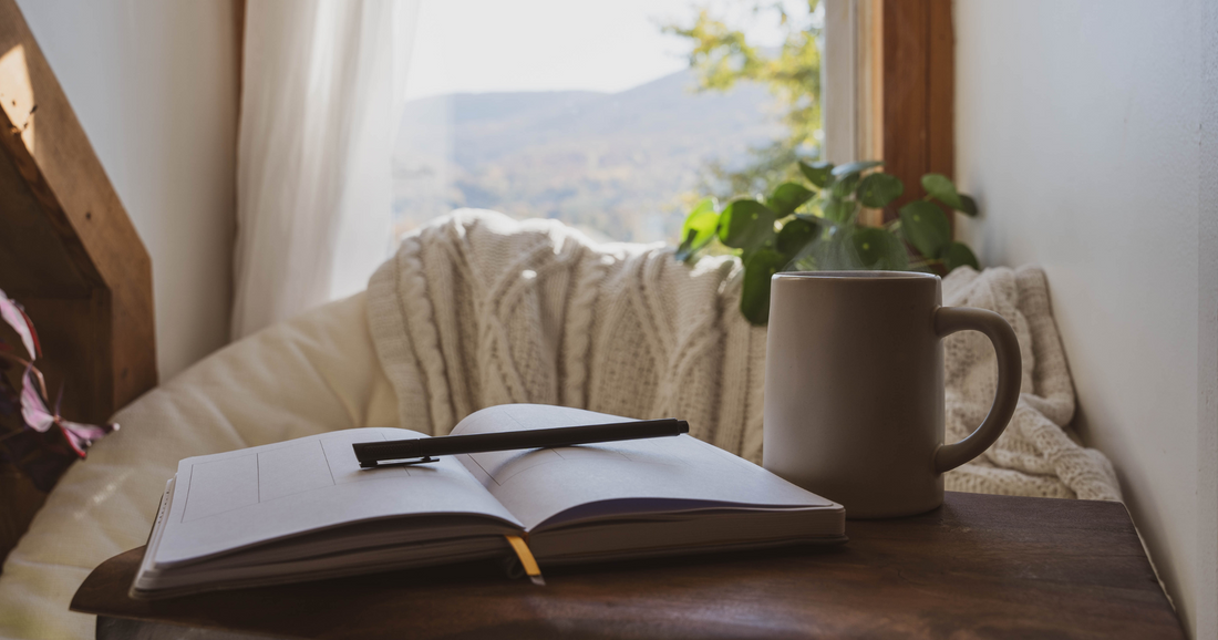 Journalling Notebook with a hot drink and a view